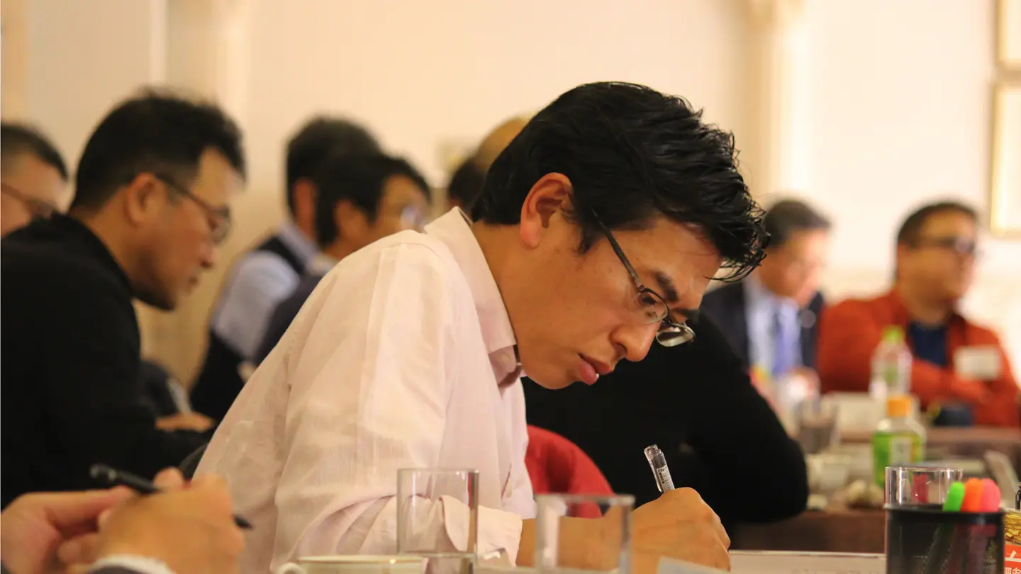 Professional taking notes during a business training session or seminar.