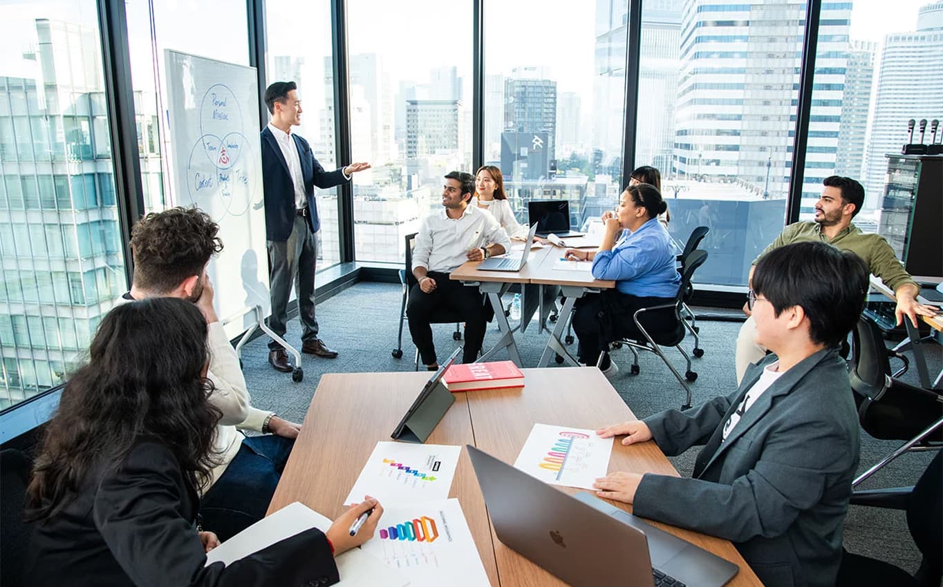 Business professionals attending a presentation in a high-rise office meeting room