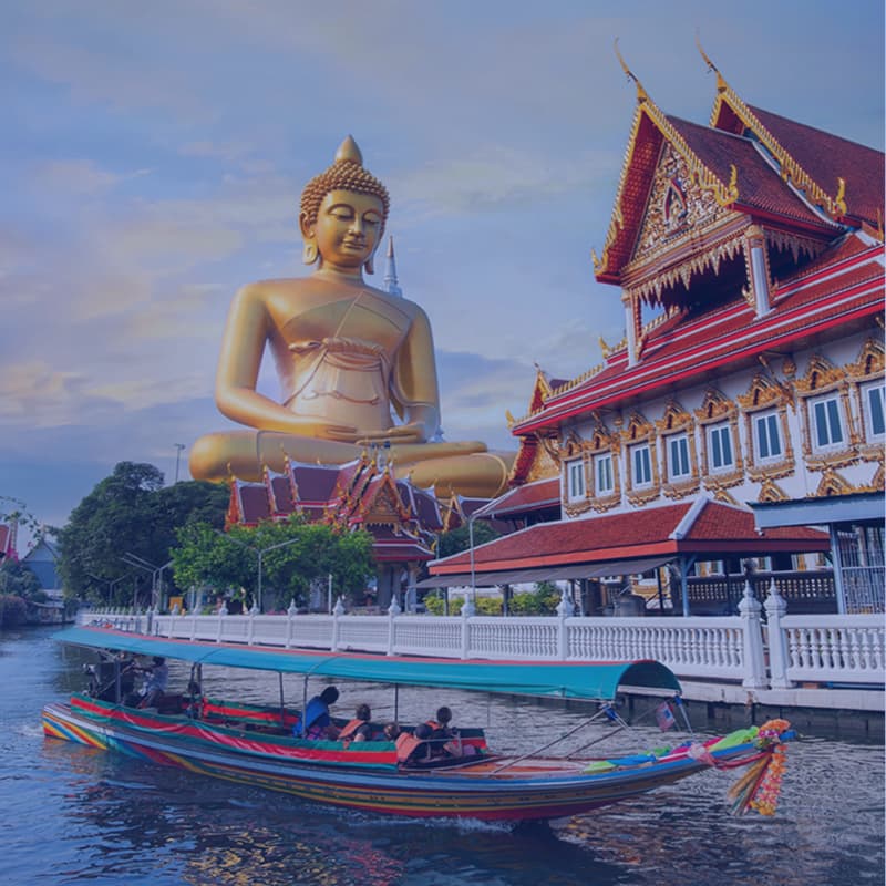 Golden Buddha statue, temple, and a longtail boat in Bangkok