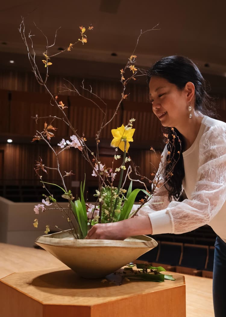 Collage of a woman arranging flowers and a woman looking up in a city.