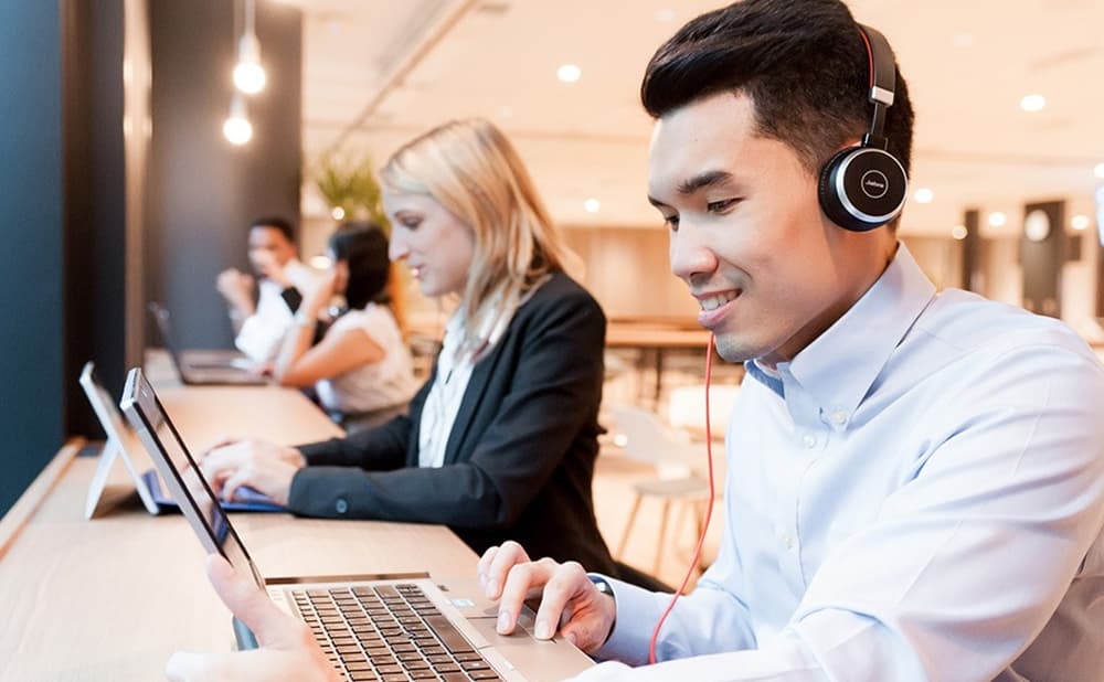 Two learners using laptops to take a business e-learning course