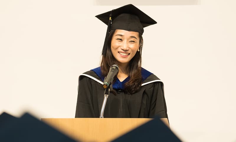 Valedictorian giving a speech at a university graduation ceremony