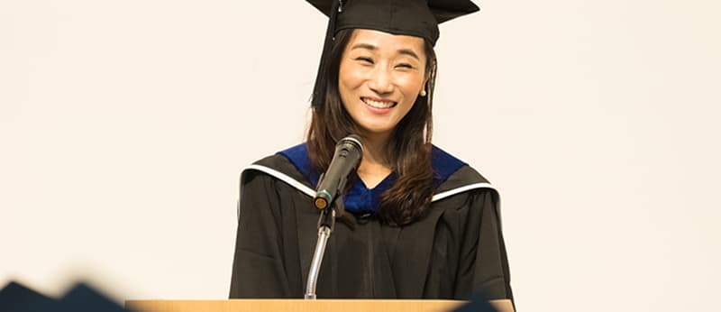 Valedictorian giving a speech at a university graduation ceremony