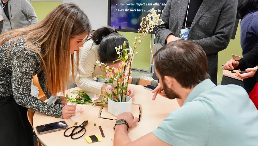 Participants practicing ikebana flower arrangement in a hands-on workshop.